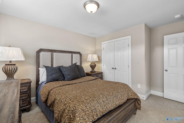 bedroom with a closet and light colored carpet