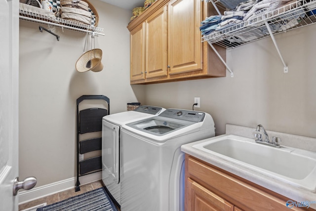 clothes washing area with cabinets, independent washer and dryer, tile patterned flooring, and sink