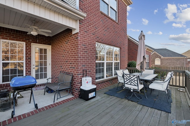 wooden terrace featuring grilling area and ceiling fan