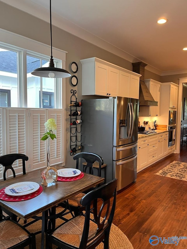 kitchen with stainless steel fridge with ice dispenser, light stone countertops, dark hardwood / wood-style flooring, white cabinetry, and decorative light fixtures