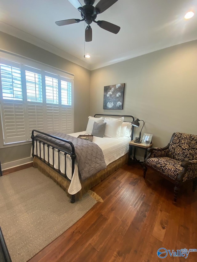 bedroom featuring ornamental molding, ceiling fan, and dark hardwood / wood-style flooring