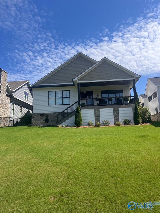 rear view of property with a yard