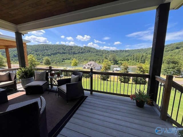 wooden deck featuring a yard and a water view