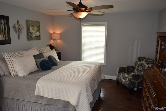 bedroom with ceiling fan and dark hardwood / wood-style floors