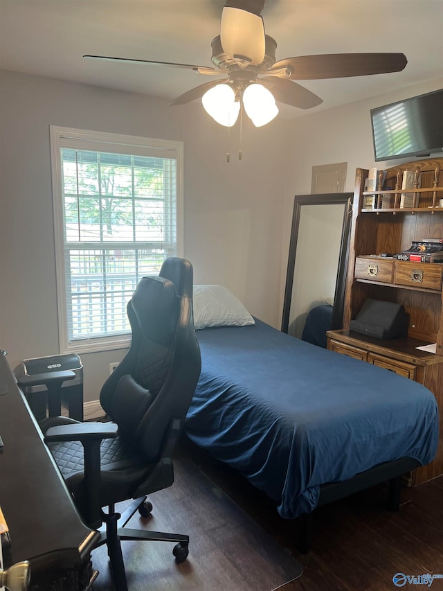 bedroom featuring dark hardwood / wood-style flooring and ceiling fan