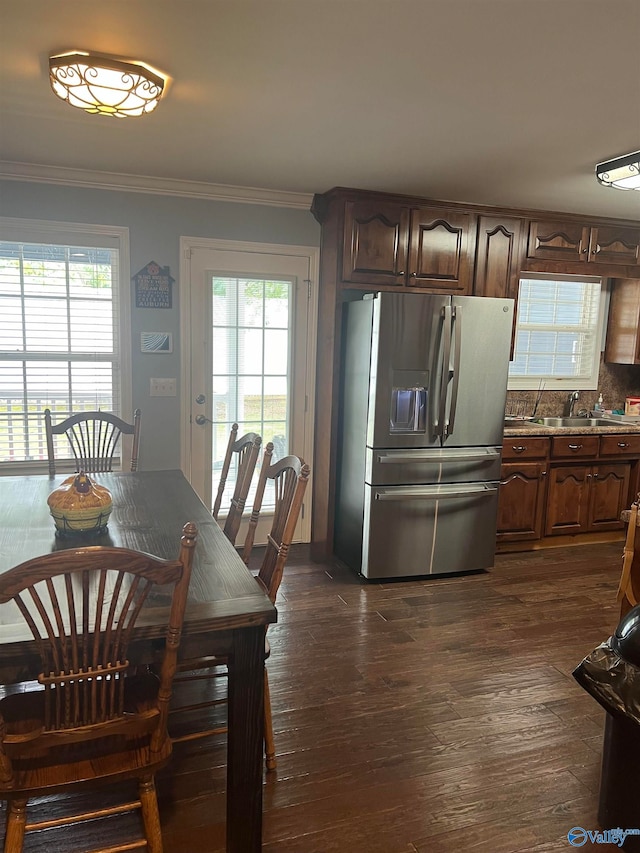 dining space with dark wood-type flooring and ornamental molding