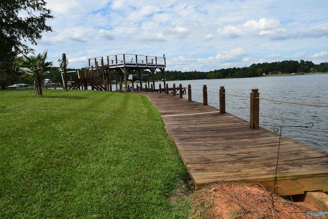 dock area featuring a water view and a lawn