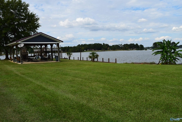 view of dock featuring a water view, a yard, and a gazebo