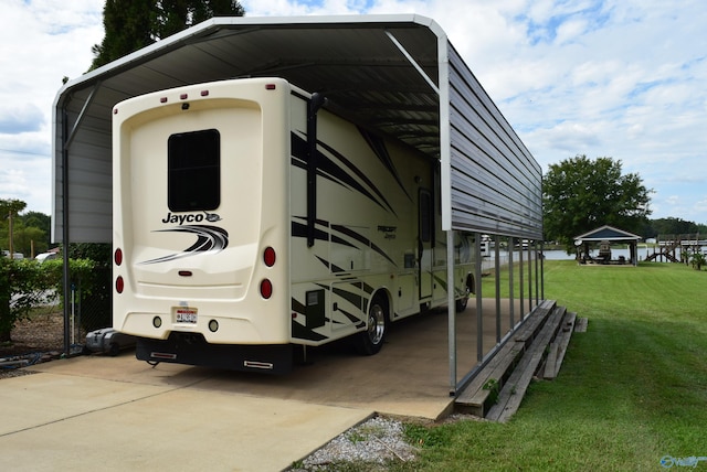 exterior space with a lawn and a carport