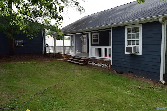 back of property with cooling unit, a lawn, and covered porch