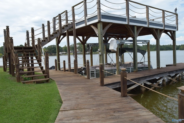 dock area featuring a lawn and a water view