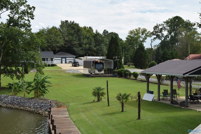 surrounding community with a water view, a lawn, a patio area, and a gazebo