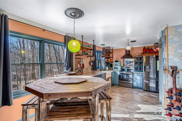 dining area featuring ornamental molding, sink, and light wood-type flooring