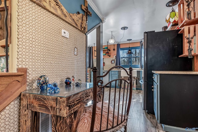 kitchen with hardwood / wood-style flooring and refrigerator