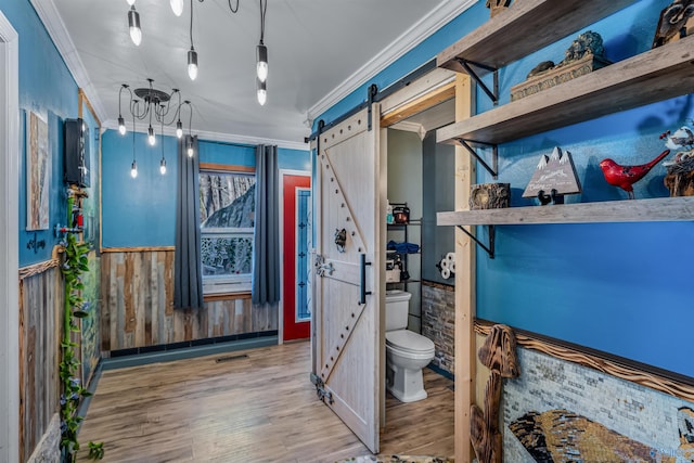 bathroom with ornamental molding, toilet, and hardwood / wood-style floors