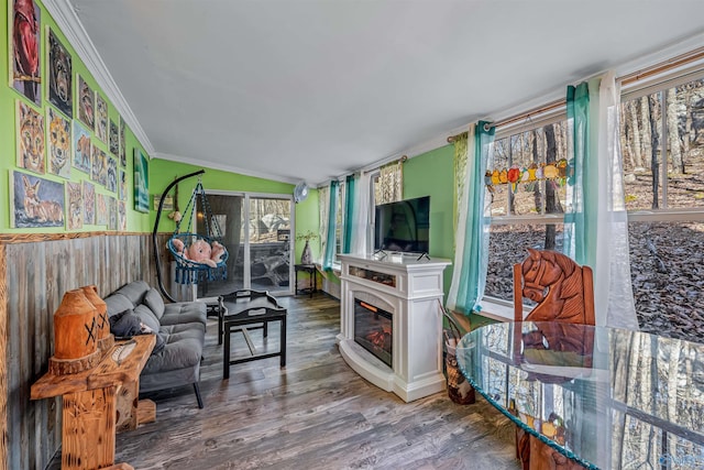 living room featuring ornamental molding, vaulted ceiling, and wood-type flooring