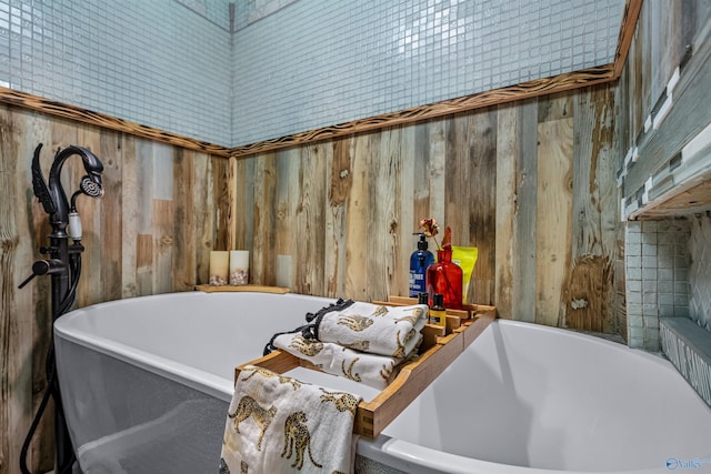 bathroom with wooden walls and a tub