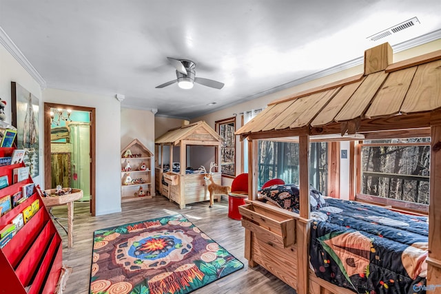 bedroom with hardwood / wood-style flooring and crown molding