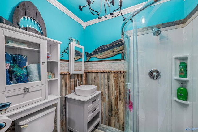 interior space featuring a shower with door, crown molding, and vanity