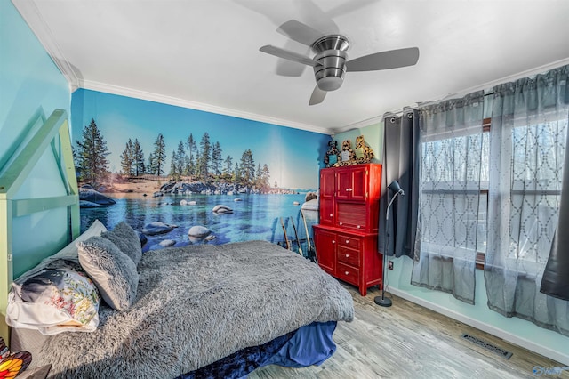 bedroom featuring ceiling fan, ornamental molding, and light hardwood / wood-style flooring