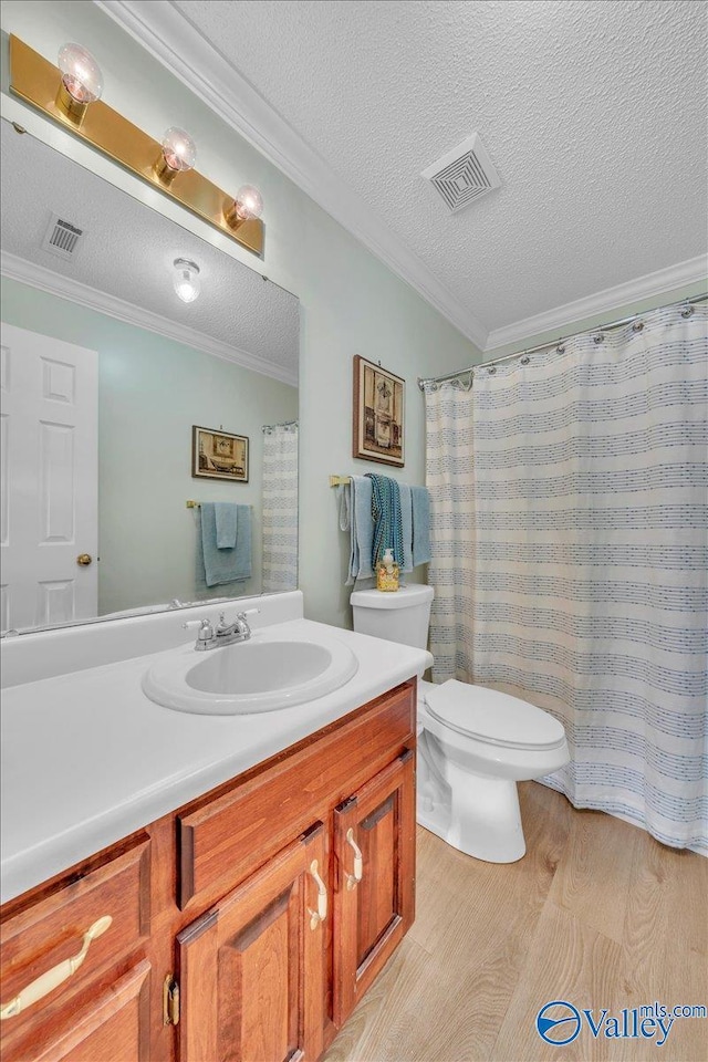 full bathroom featuring toilet, wood finished floors, visible vents, and crown molding