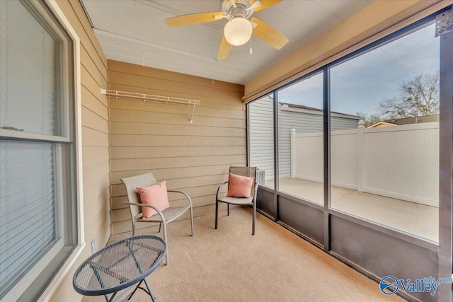 sunroom / solarium with a ceiling fan