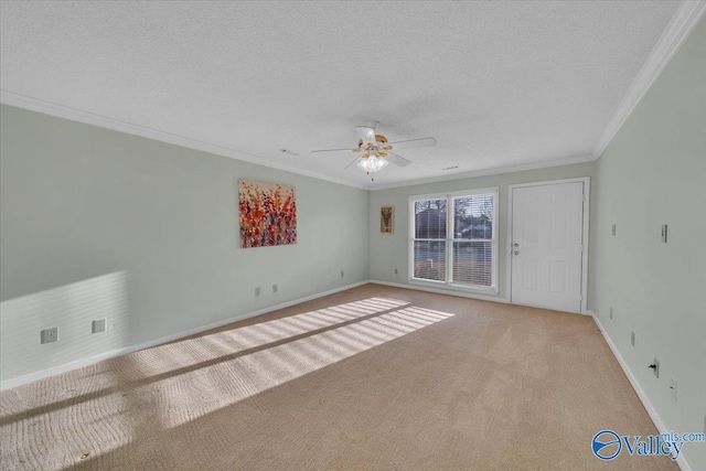 unfurnished room featuring light colored carpet, crown molding, a textured ceiling, and ceiling fan