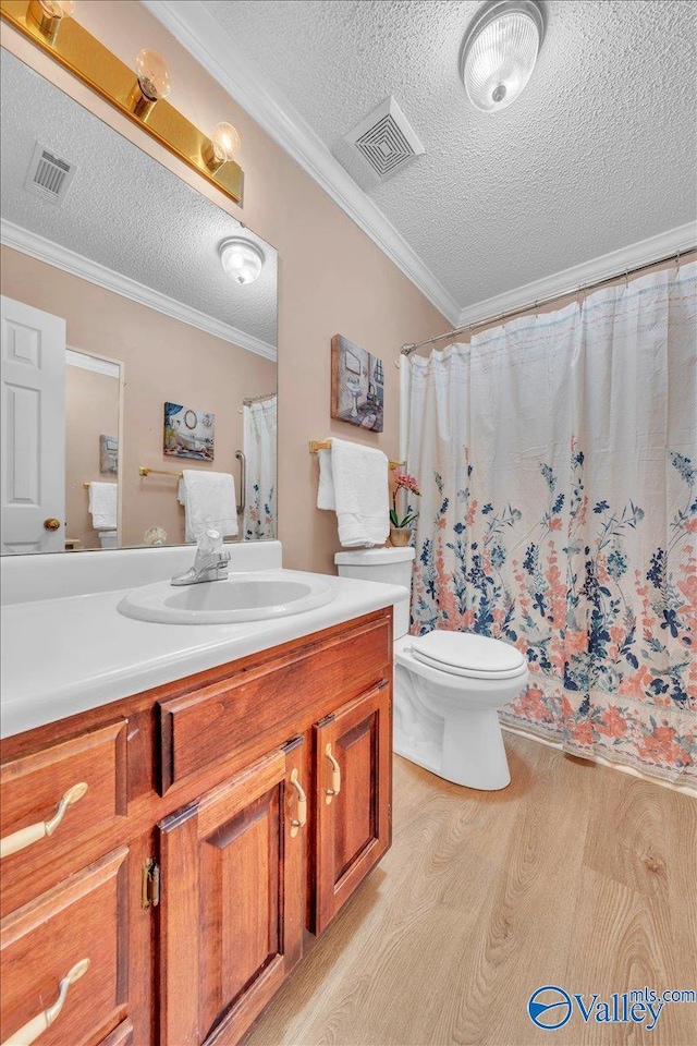 full bathroom with ornamental molding, wood finished floors, and visible vents