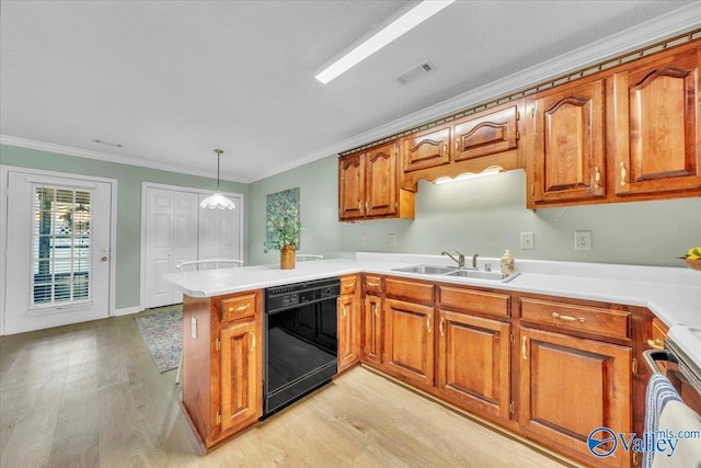 kitchen with light wood finished floors, black dishwasher, brown cabinetry, a peninsula, and a sink