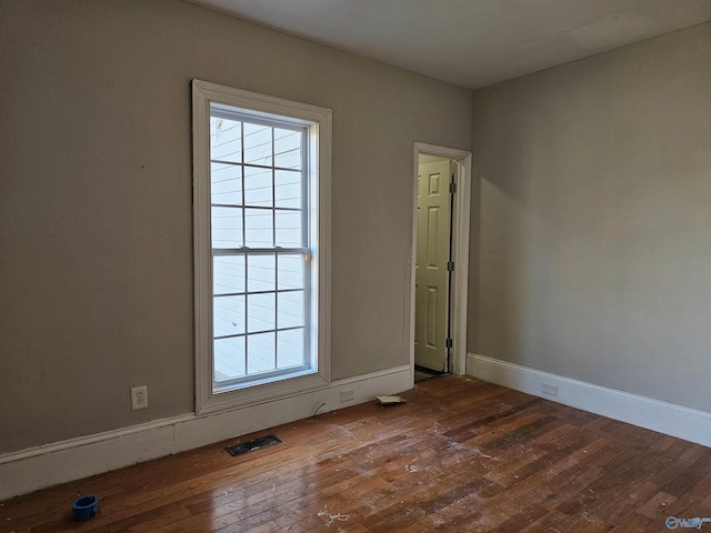 spare room with wood-type flooring