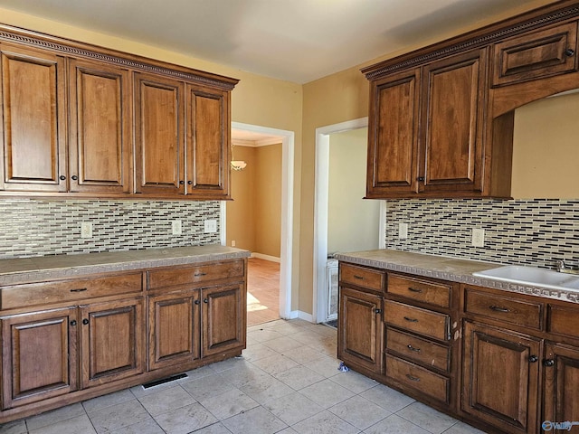 kitchen with sink, backsplash, and light tile patterned floors