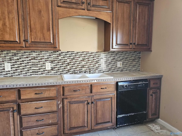 kitchen featuring light tile patterned floors, backsplash, dishwasher, and sink