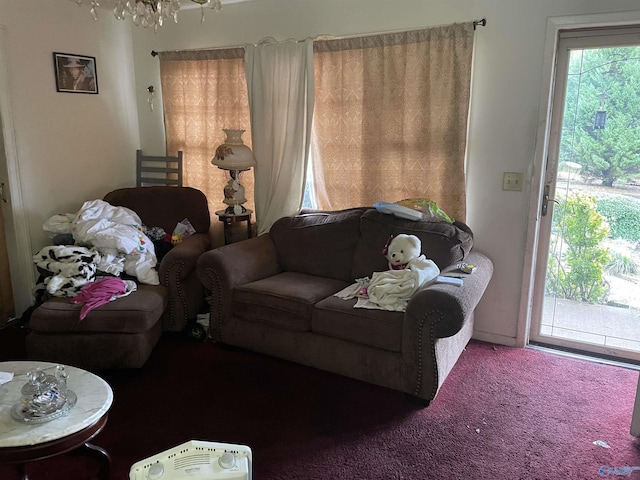 living room with carpet flooring and a chandelier