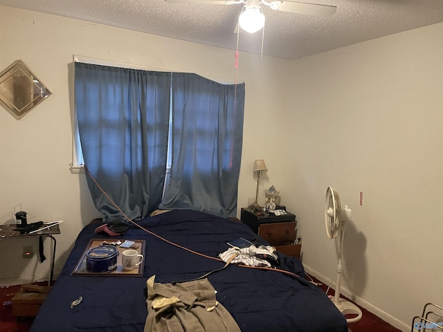 bedroom with ceiling fan and a textured ceiling