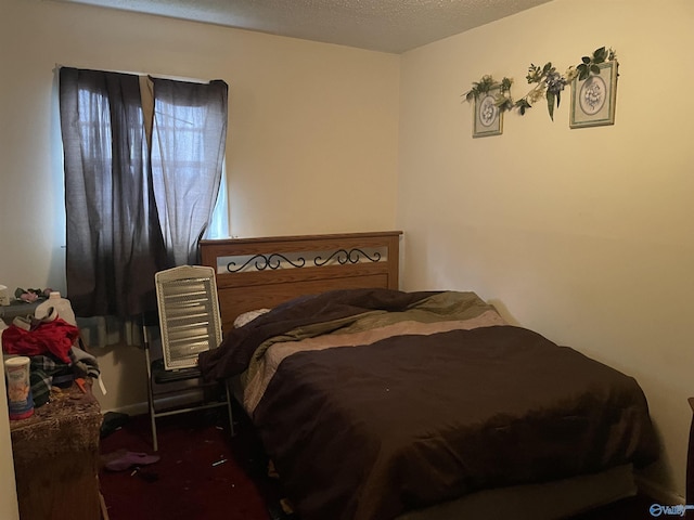 bedroom with carpet and a textured ceiling