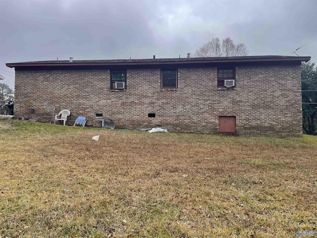 rear view of house featuring a yard and cooling unit