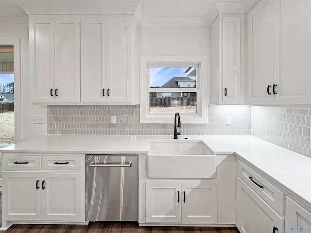 kitchen with a sink, white cabinets, light countertops, backsplash, and dishwasher