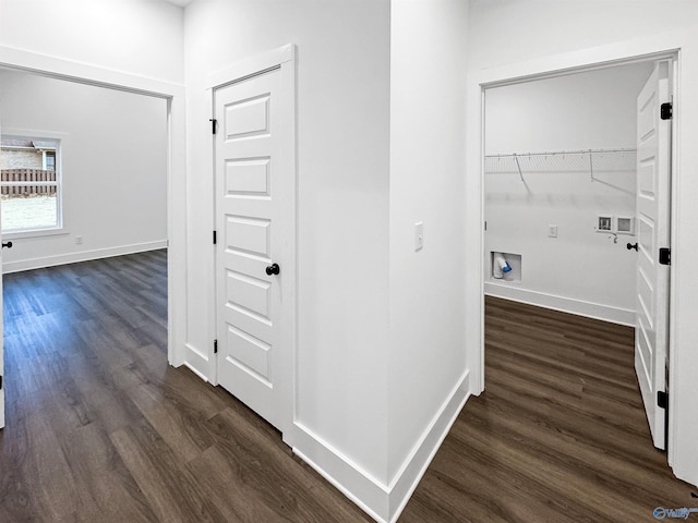 hallway featuring dark wood-style floors and baseboards