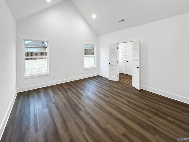 unfurnished bedroom with high vaulted ceiling, visible vents, baseboards, and dark wood-style floors