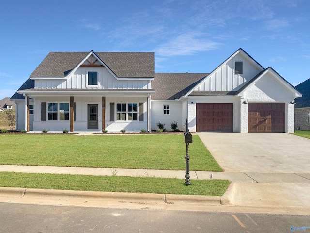 modern farmhouse style home with a front lawn, covered porch, and a garage