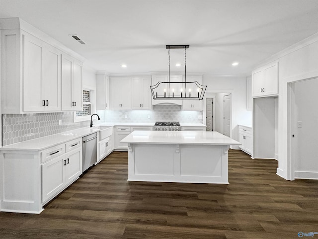 kitchen with a kitchen island, visible vents, dishwasher, and white cabinetry