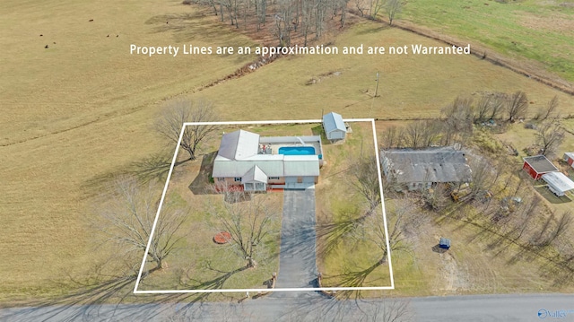 birds eye view of property with a rural view