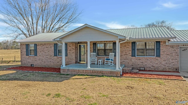 single story home with a porch, a garage, and a front lawn