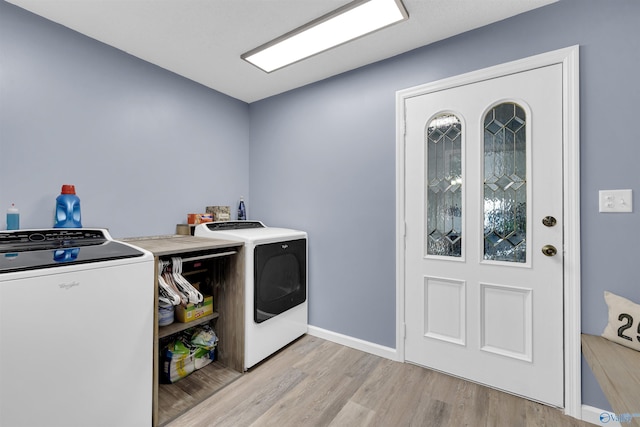 washroom featuring light wood-type flooring and washing machine and clothes dryer