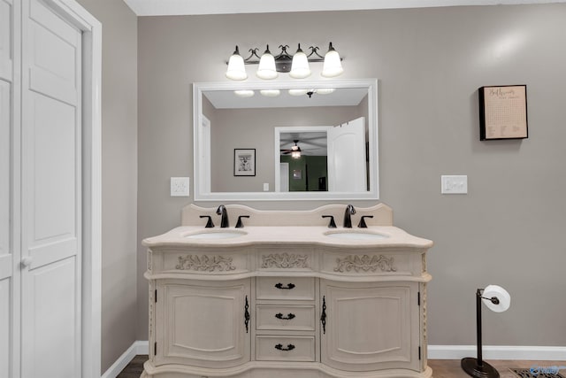 bathroom with wood-type flooring, vanity, and ceiling fan