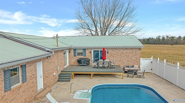 back of house featuring a swimming pool side deck and a patio