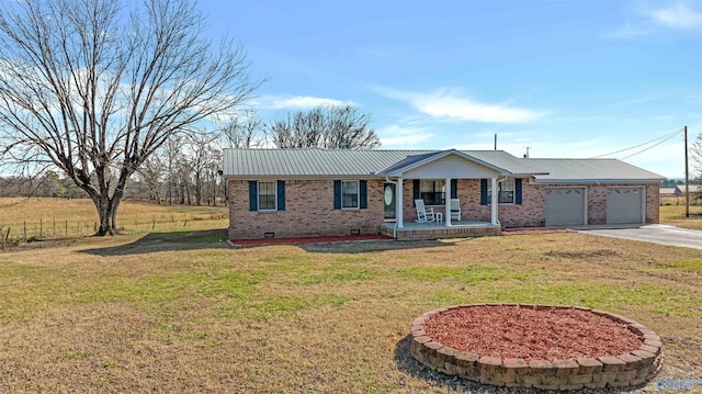 single story home with a garage, a porch, and a front yard