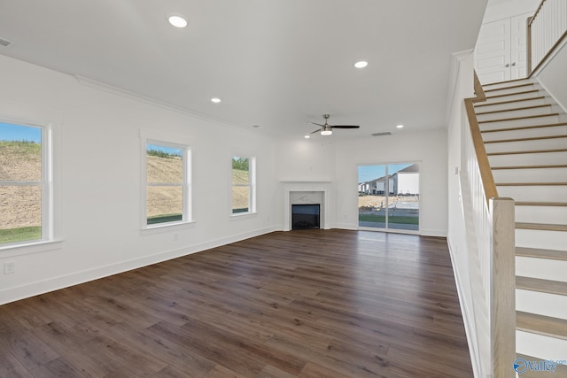 unfurnished living room with crown molding, ceiling fan, and dark hardwood / wood-style floors