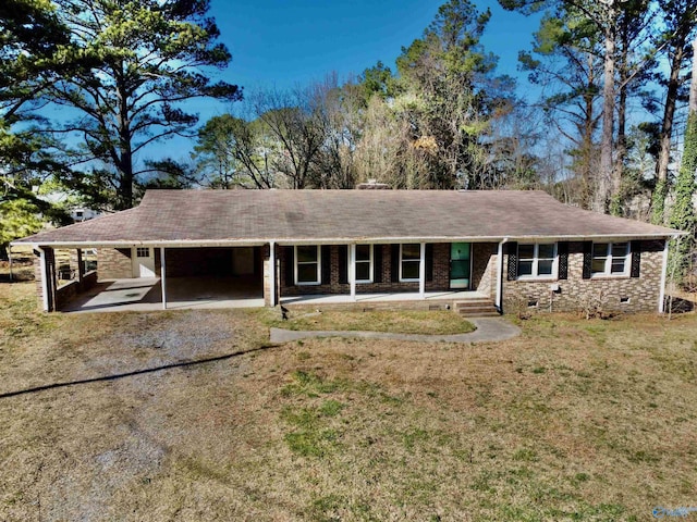 ranch-style home with brick siding, crawl space, an attached carport, driveway, and a front lawn