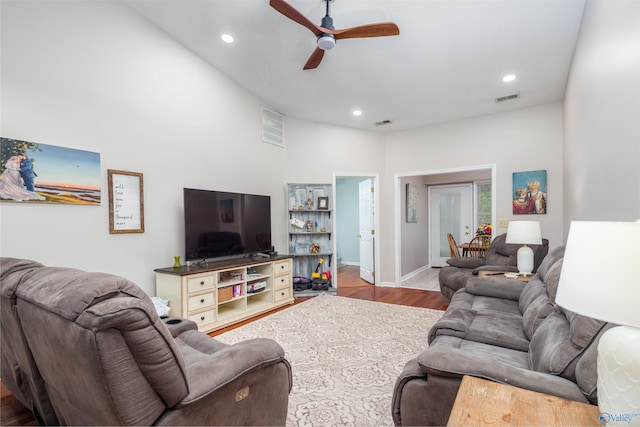 living room featuring light hardwood / wood-style flooring and ceiling fan